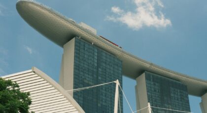View of the distinctive Marina Bay Sands Hotel in Singapore under a clear blue sky.