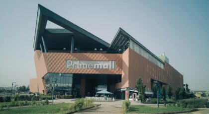 Exterior of modern Prime Mall shopping center in urban Turkey, showcasing architectural design.