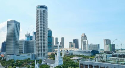 View of Singapore's modern skyline featuring iconic architecture and lush greenery, captured on a sunny day.