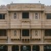 Impressive stone facade of a palace hotel in Jaisalmer, showcasing intricate architectural details.