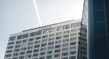Modern Hilton Hotel building in Québec City captured from a low angle with clear blue skies.