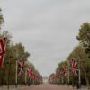 Scenic view of The Mall in London adorned with Union Flags, leading to Buckingham Palace.