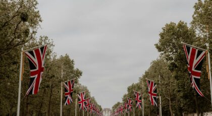 Scenic view of The Mall in London adorned with Union Flags, leading to Buckingham Palace.