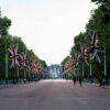 The Mall in London decorated with British flags, leading to Buckingham Palace.