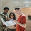 Young adults examining a map indoors at Grand Central Terminal.