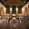 Grand Central Terminal's vast interior captured at night, highlighting its architectural grandeur and bustling atmosphere.