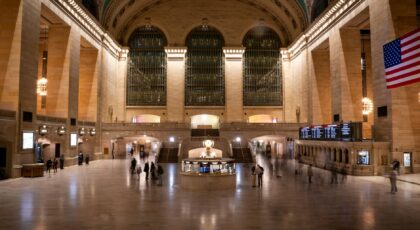 Grand Central Terminal's vast interior captured at night, highlighting its architectural grandeur and bustling atmosphere.
