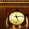 An antique clock at Grand Central Station, New York City, glowing warmly.