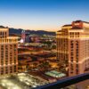 Stunning aerial view of the illuminated Bellagio Hotel and Las Vegas skyline during twilight.