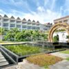 Elegant resort featuring a decorative fountain, lush gardens, and stunning architecture, perfect for relaxation.