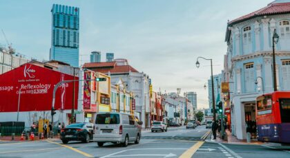 Vibrant street scene in Singapore with iconic architecture and city traffic.